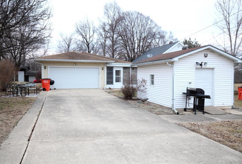 Ranch-style house with a garage and an outbuilding