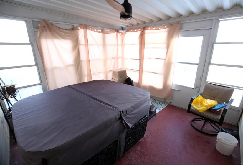 Sunroom with ceiling fan and a healthy amount of sunlight