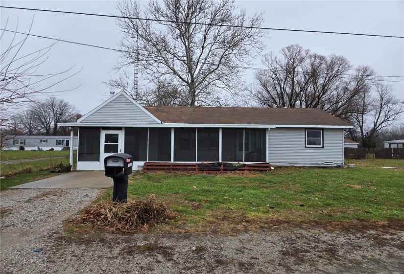 View of front of home featuring a screened in porch.